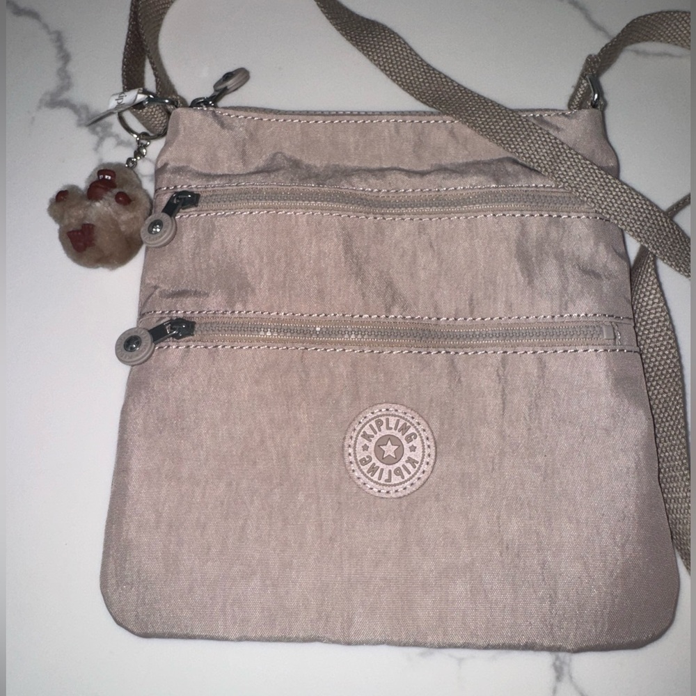 Kipling Tan Crossbody Bag with Adjustable Strap and Signature Charm